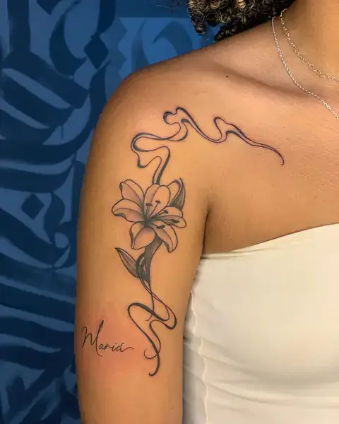 Tatuagem fine line de lírio com nome no braço